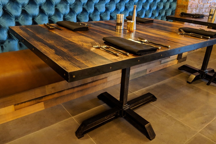 Downstairs & Upstairs Dining Rooms: Reclaimed barnwood tables with custom steel bases, and steel & nailhead edge trim